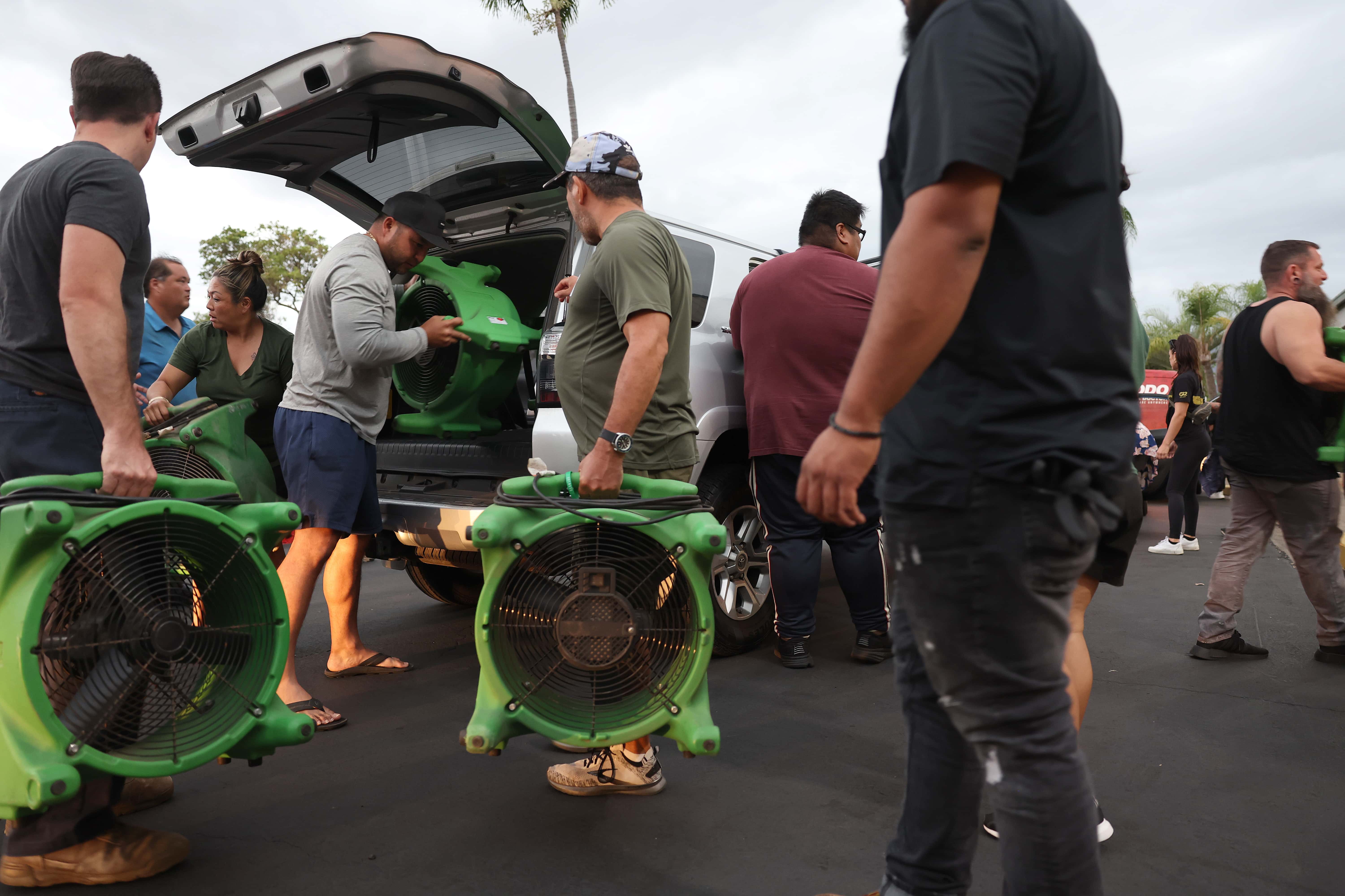 Volunteers with King's Cathedral Maui unload a donation of industrial fans on August 10, 2023 in Kahului, Hawaii. Dozens of people were killed and thousands displaced after a wind-driven wildfire devastated the town of Lahaina on Tuesday. King's Cathedral Maui is providing food and shelter for displaced families.