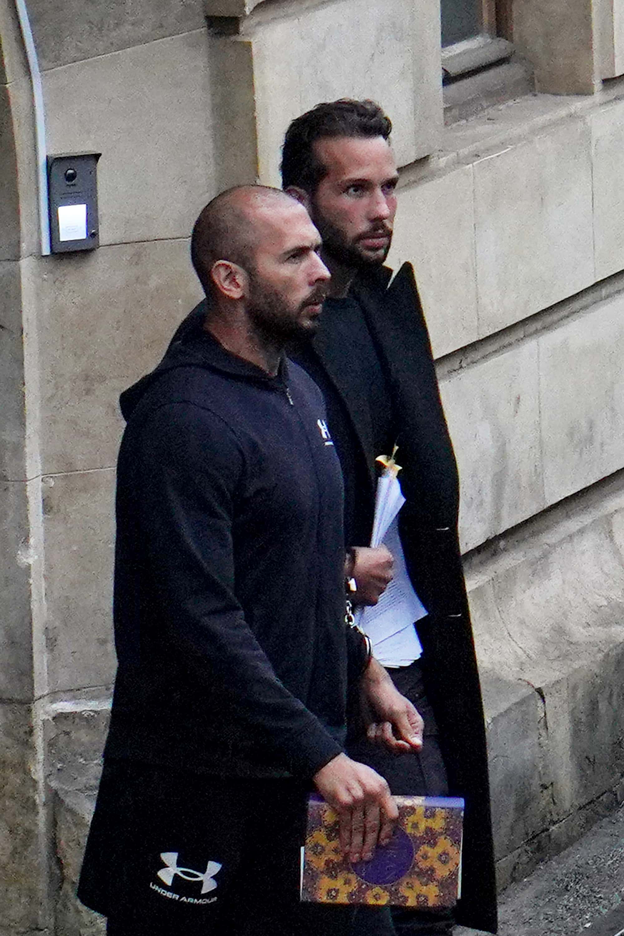 BUCHAREST, ROMANIA - JANUARY 10: Andrew Tate (L) and Tristan Tate leave the Bucharest Court of Appea