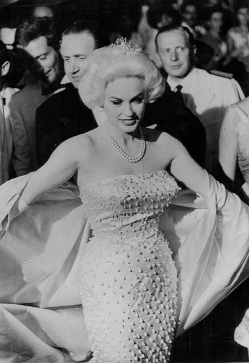Actress Mamie Van Doren sitting showing off her gown as she arrives at the premiere of the film 'Man in a Rickshaw', at Venice Film Festival, Italy, September 1st 1958. (Photo by Keystone/Hulton Archive/Getty Images)