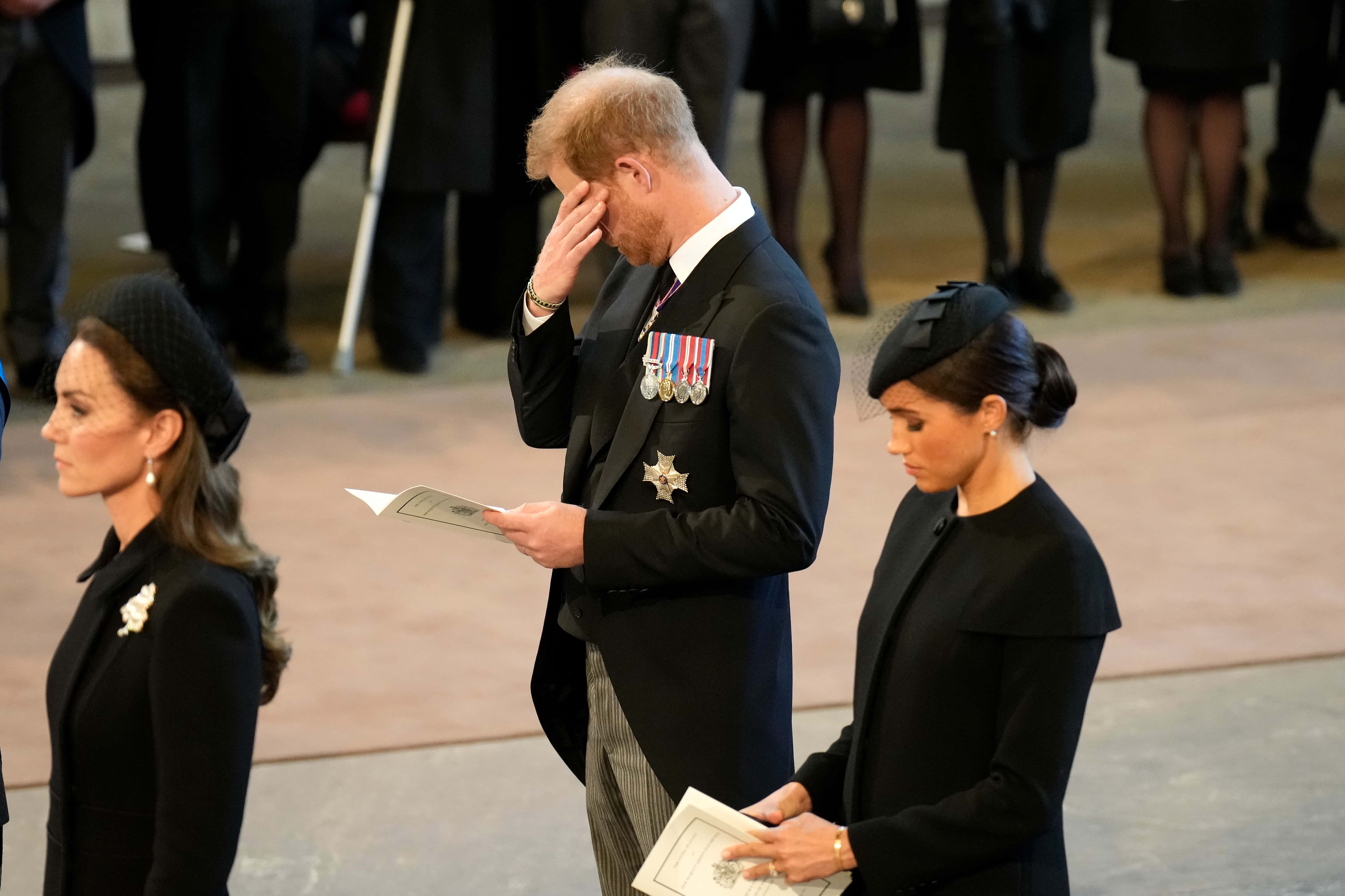 Catherine, Princess of Wales, Prince Harry, Duke of Sussex and Meghan, Duchess of Sussex pay their respects in The Palace of Westminster after the procession for the Lying-in State of Queen Elizabeth II on September 14, 2022 in London, England. Queen Elizabeth II's coffin is taken in procession on a Gun Carriage of The King's Troop Royal Horse Artillery from Buckingham Palace to Westminster Hall where she will lay in state until the early morning of her funeral. Queen Elizabeth II died at Balmoral Castle in Scotland on September 8, 2022, and is succeeded by her eldest son, King Charles III.