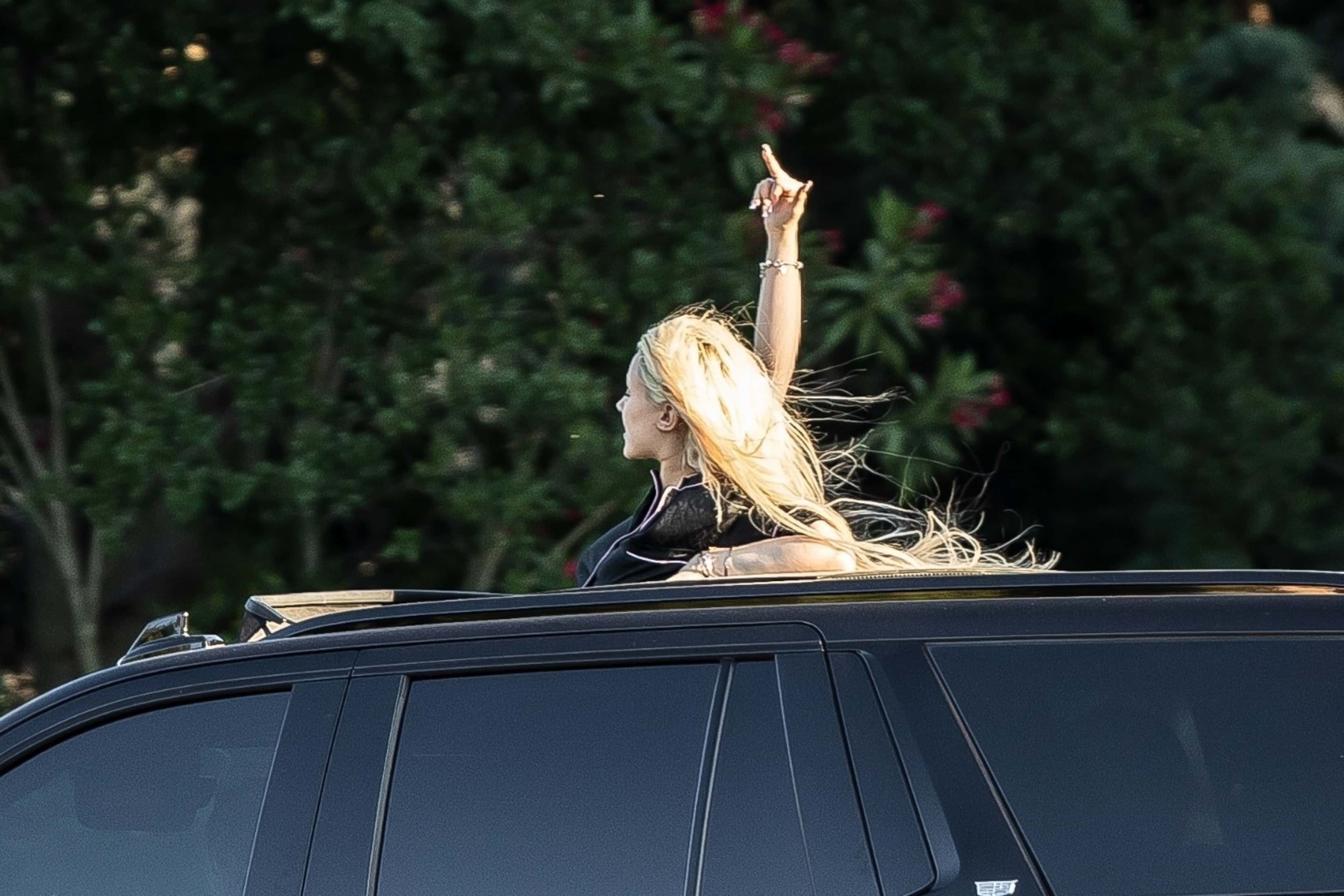 Unleashing her wild side, Grammy winner Travis Barker's youngest offspring, Alabama Luella Barker, boldly popped out of the sunroof of a sleek black Cadillac Escalade SUV, cruising around Calabasas with her pals on a thrilling Monday escapade (Backgrid)