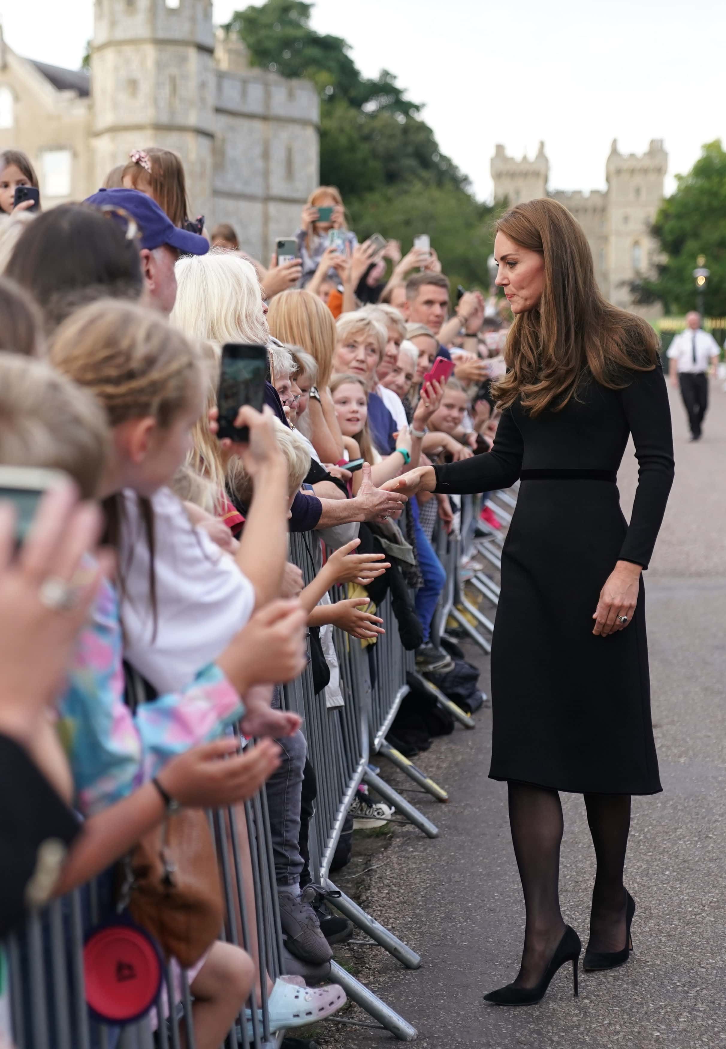 Catherine, Princess of Wales meets members of the public on the long Walk at Windsor Castle on September 10, 2022 in Windsor, England. Crowds have gathered and tributes left at the gates of Windsor Castle to Queen Elizabeth II, who died at Balmoral Castle on 8 September, 2022.