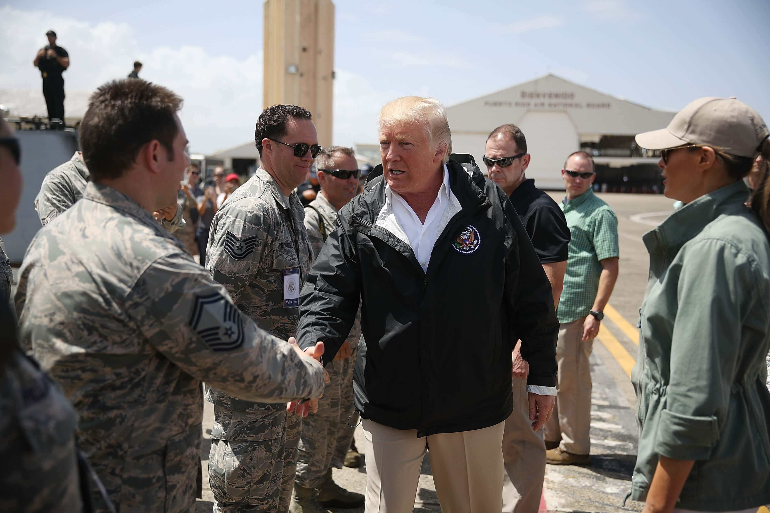 CAROLINA, PUERTO RICO - OCTOBER 03: US President Donald Trump greets U.S Air Force airmen as he arrives at the Muniz Air National Guard Base as he makes a visit after Hurricane Maria hit the island on October 3, 2017 in Carolina, Puerto Rico. The President has been criticized by some that say the government's response has been inadequate. (Photo by Joe Raedle/Getty Images)