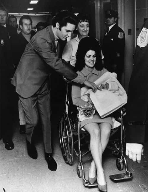 Singer Elvis Presley (1935 - 1977), 33, and his 22 year-old wife Priscilla, leaving the Baptist Hospital, Memphis, Tennessee, with their baby daughter Lisa-Marie, born at the hospital on February 2nd.    (Photo by Keystone/Getty Images)