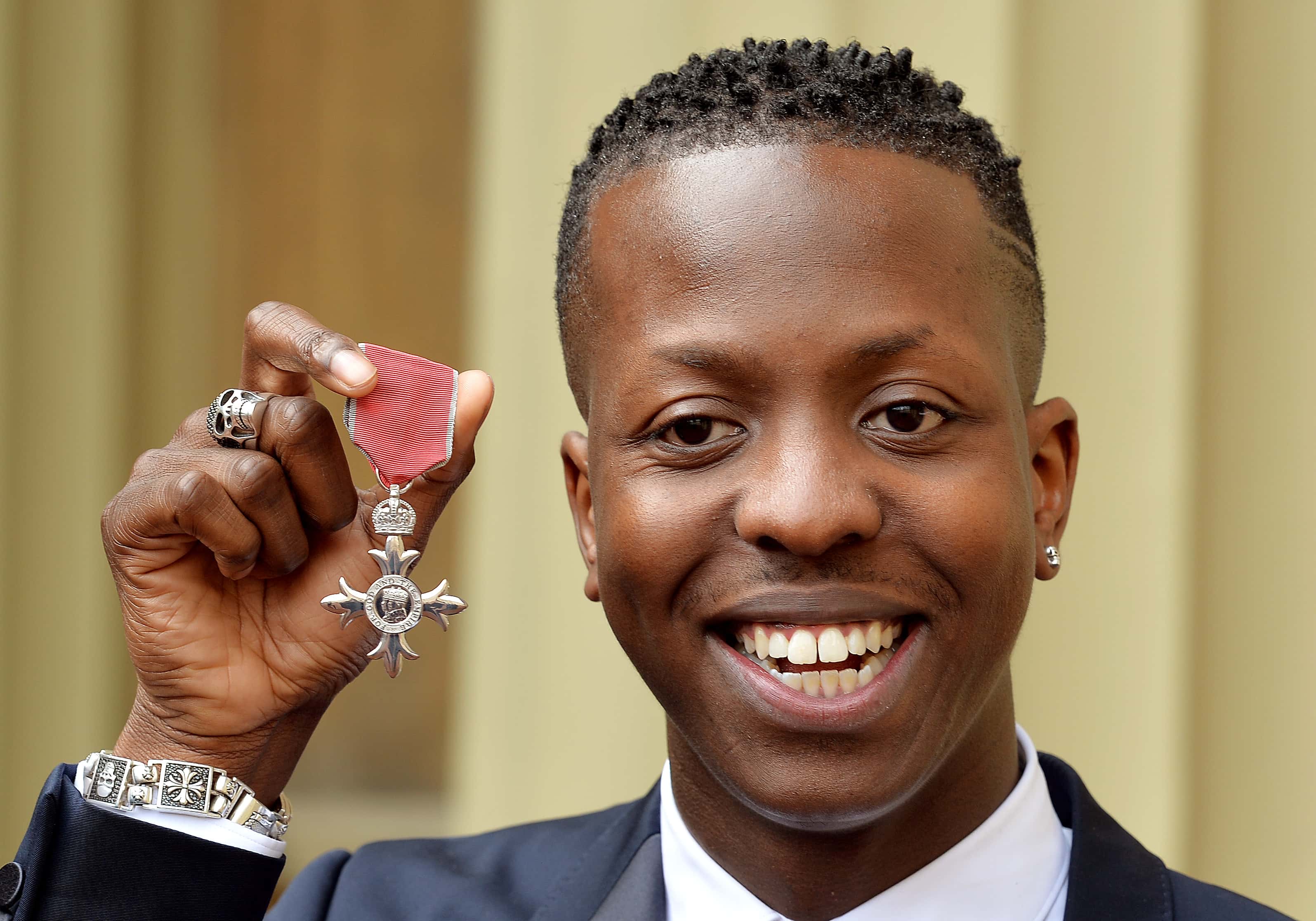 Jamal Edwards holds his Member of the British Empire (MBE), after it was awarded to him by the Prince of Wales at an Investiture Ceremony at Buckingham Palace on March 26, 2015 in London, England.