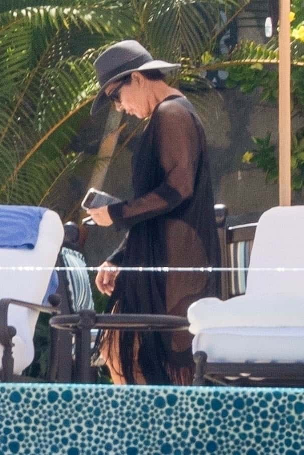Kris was clad in a plunging sheer black cover-up that revealed a bathing suit underneath (backgrid)

