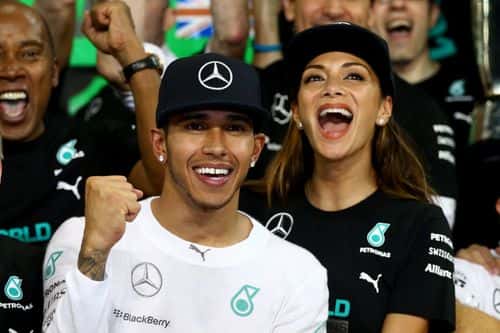 Lewis Hamilton of Great Britain and Mercedes GP celebrates with his team and Nicole Scherzinger after winning the World Championship after the Abu Dhabi Formula One Grand Prix at Yas Marina Circuit on November 23, 2014 in Abu Dhabi, United Arab Emirates.