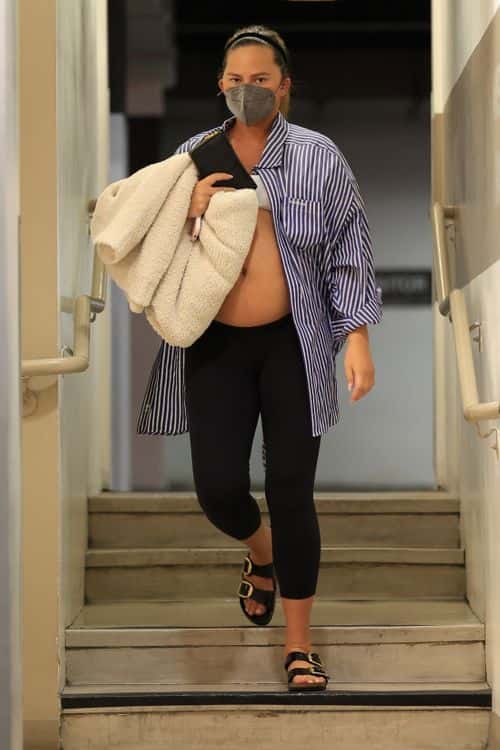 Chrissy Teigen shows off baby bump in unbuttoned shirt. (Photo: Backgrid)