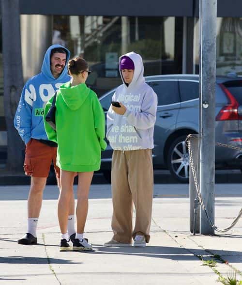 Hailey and Justin Beiber talk while a friend lingers nearby  (Backgrid)