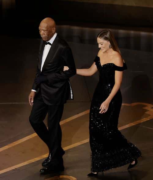 (L-R) Morgan Freeman and Margot Robbie walk onstage during the 95th Annual Academy Awards at Dolby Theatre on March 12, 2023 in Hollywood, California.