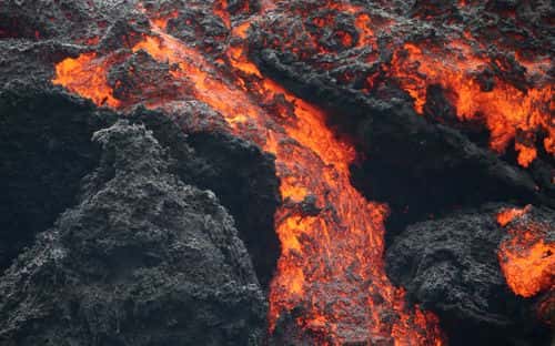Lava flows at a lava fissure in the aftermath of eruptions from the Kilauea volcano on Hawaii's Big Island, on May 12, 2018 in Pahoa, Hawaii. The U.S. Geological Survey said a recent lowering of the lava lake at the volcano's Halemaumau crater Òhas raised the potential for explosive eruptionsÓ at the volcano. Authorities have confirmed the fissure is the 16th to open.