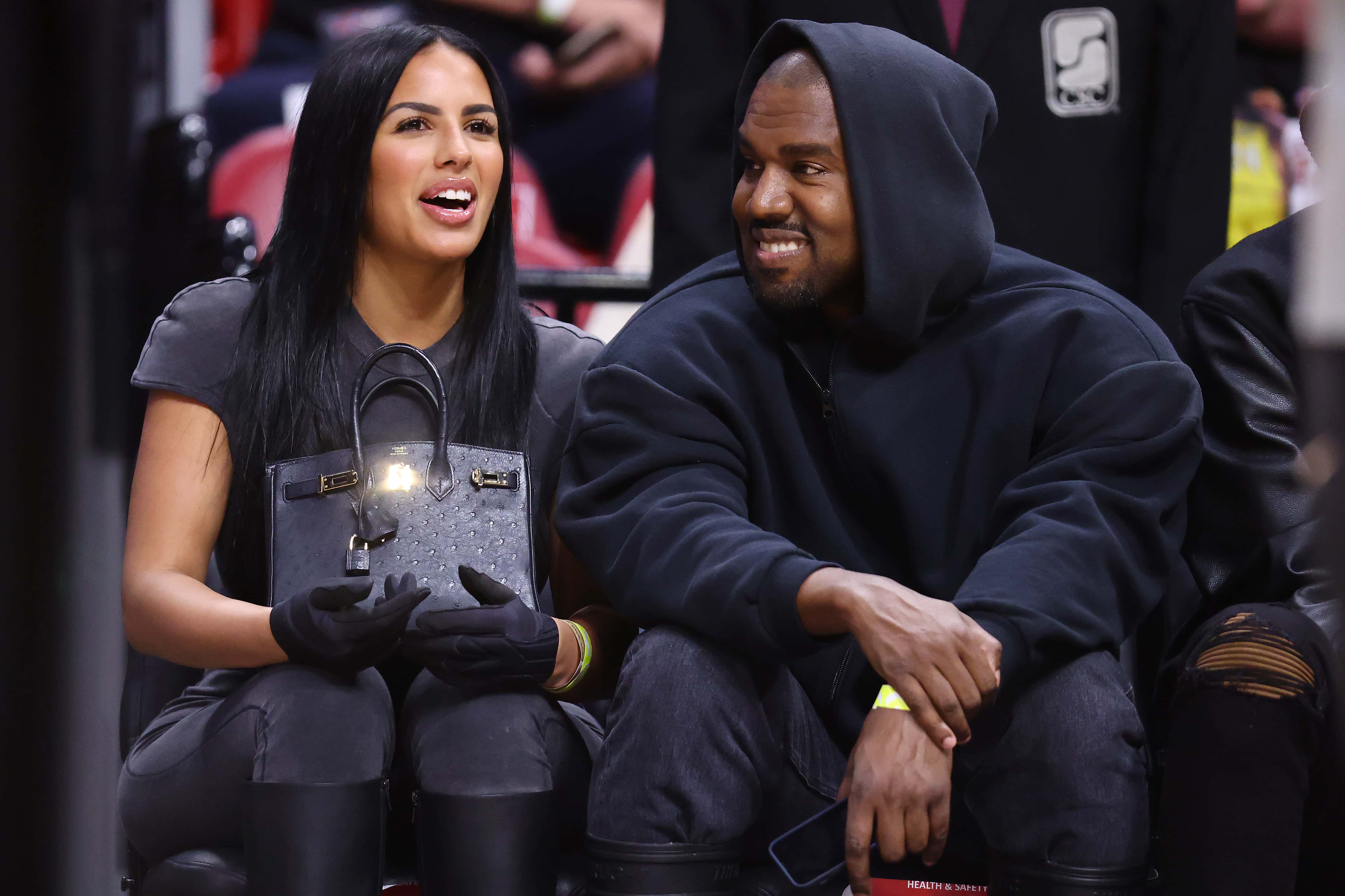 Rapper Kanye West and girlfriend Chaney Jones attend a game between the Miami Heat and the Minnesota Timberwolves at FTX Arena on March 12, 2022 in Miami, Florida. NOTE TO USER: User expressly acknowledges and agrees that, by downloading and or using this photograph, User is consenting to the terms and conditions of the Getty Images License Agreement.
