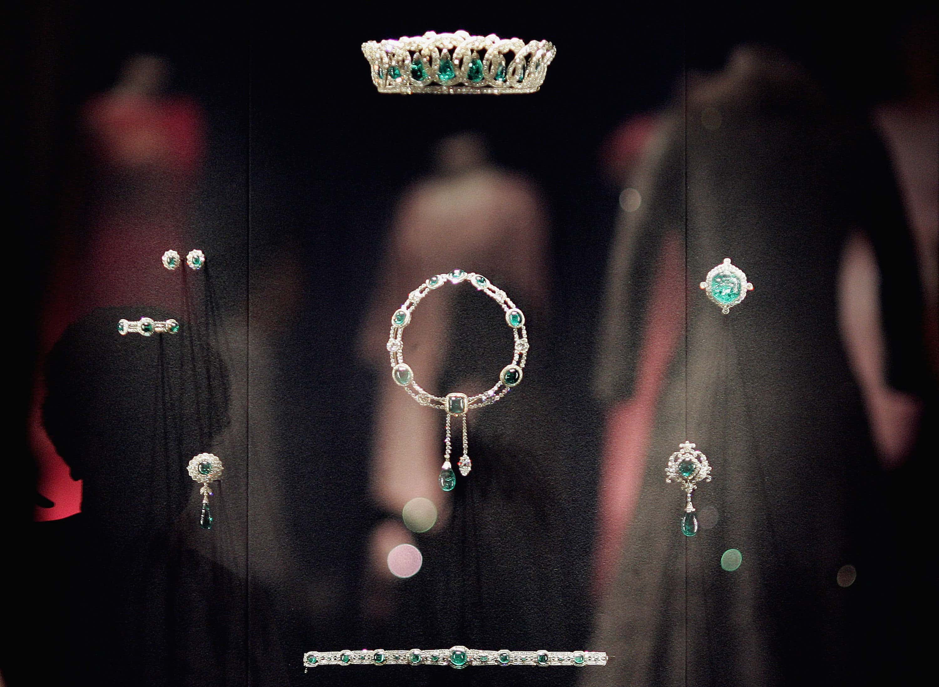Queen Elizabeth II's dresses are reflected in a glass case displaying The Vladimir Tiara and The Delhi Durbar necklace at Buckingham Palace on July 25, 2006 in London. Celebrating the Queen's 80th birthday, the largest ever exhibition of 80 gowns and jewellery from the 1940's to the present day, worn by her majesty on private and official engagements, will go on show to the public in the State Rooms during the summer opening of the palace.