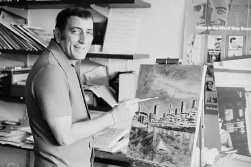 American singer Tony Bennett painting a city landscape, UK, 11th June 1971. (Photo by Daily Express/Getty Images)