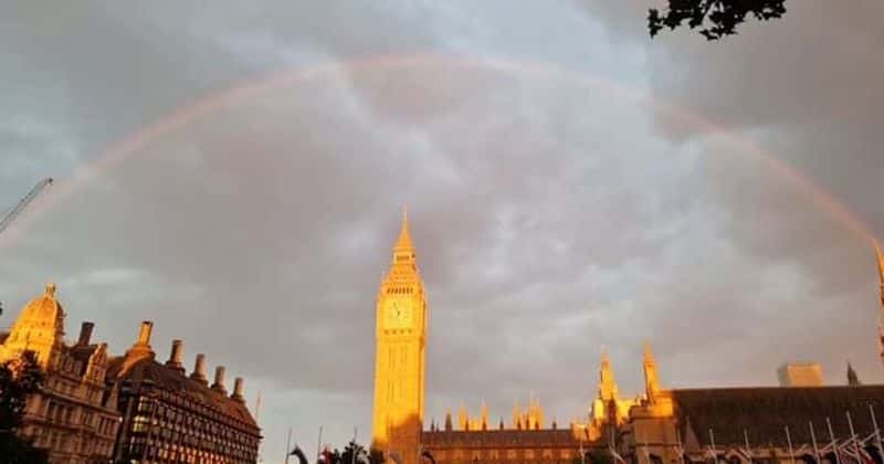 A rainbow is seen over Westminster Hall on September 18 as people continue to join the queue to see the Queen lying in state (Photo via Katy Stanley/Twitter)