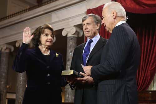 U.S. Sen. Dianne Feinstein (D-CA) (L) participates in a reenacted swearing-in with her husband Richard C. Blum and U.S. Vice President Joe Biden in the Old Senate Chamber at the U.S. Capitol  January 3, 2013 in Washington, DC. Biden swore in the newly-elected and re-elected senators earlier in the day on the floor of the current Senate chamber.