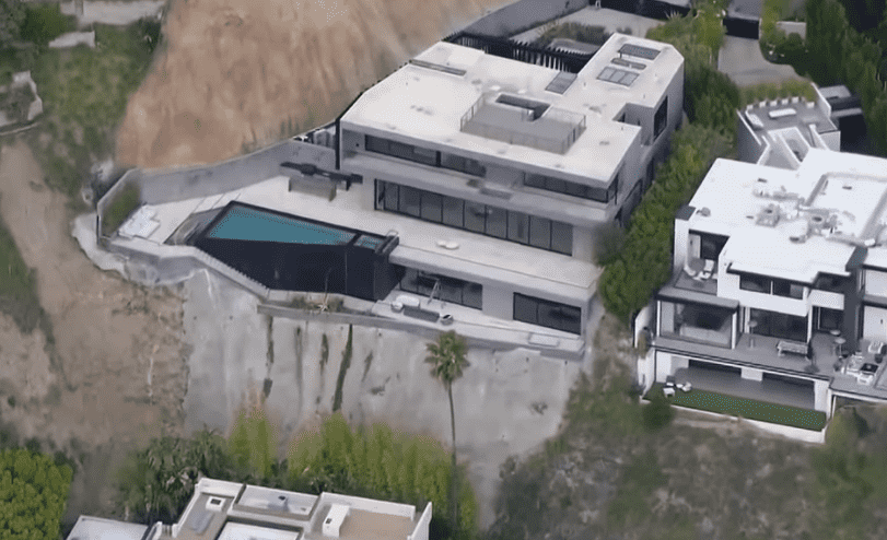 Castro's Hollywood Hills home offers the epitome of outdoor luxury, with an infinity pool, a fireplace, and seven-car garage, all encased by glass walls that provide a panoramic view of the Los Angeles cityscape (