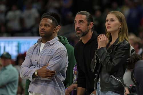 (L-R) Randall Cobb, Aaron Rodgers and Mallory Edens watch Game Two of the Eastern Conference First Round Playoffs between the Milwaukee Bucks and the Chicago Bulls at Fiserv Forum on April 20, 2022 in Milwaukee, Wisconsin. NOTE TO USER: User expressly acknowledges and agrees that, by downloading and or using this photograph, User is consenting to the terms and conditions of the Getty Images License Agreement.