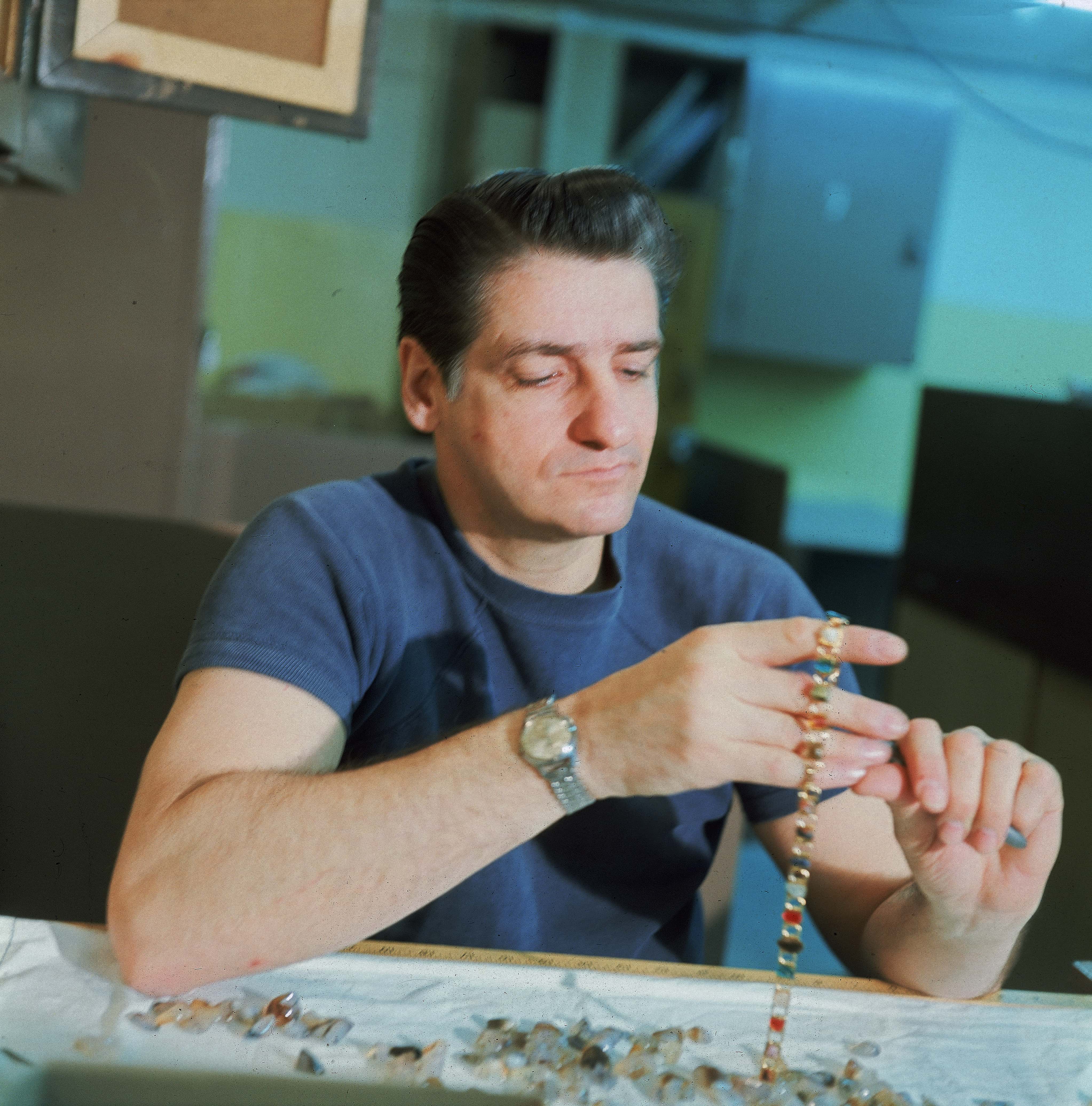 American Albert DeSalvo (1931 - 1973) shows off his jewelry-making skills at Walpole State Prison, South Walpole, Massachusetts, early 1970s. DeSalvo is the alleged Boston Strangler, a serial killer who claimed at least 11 women's lives between 1962 and 1964, DeSalvo confessed to the murders, but there has always been a shadow of doubt concerning his guilt. (Photo by Hulton Archive/Getty Images)