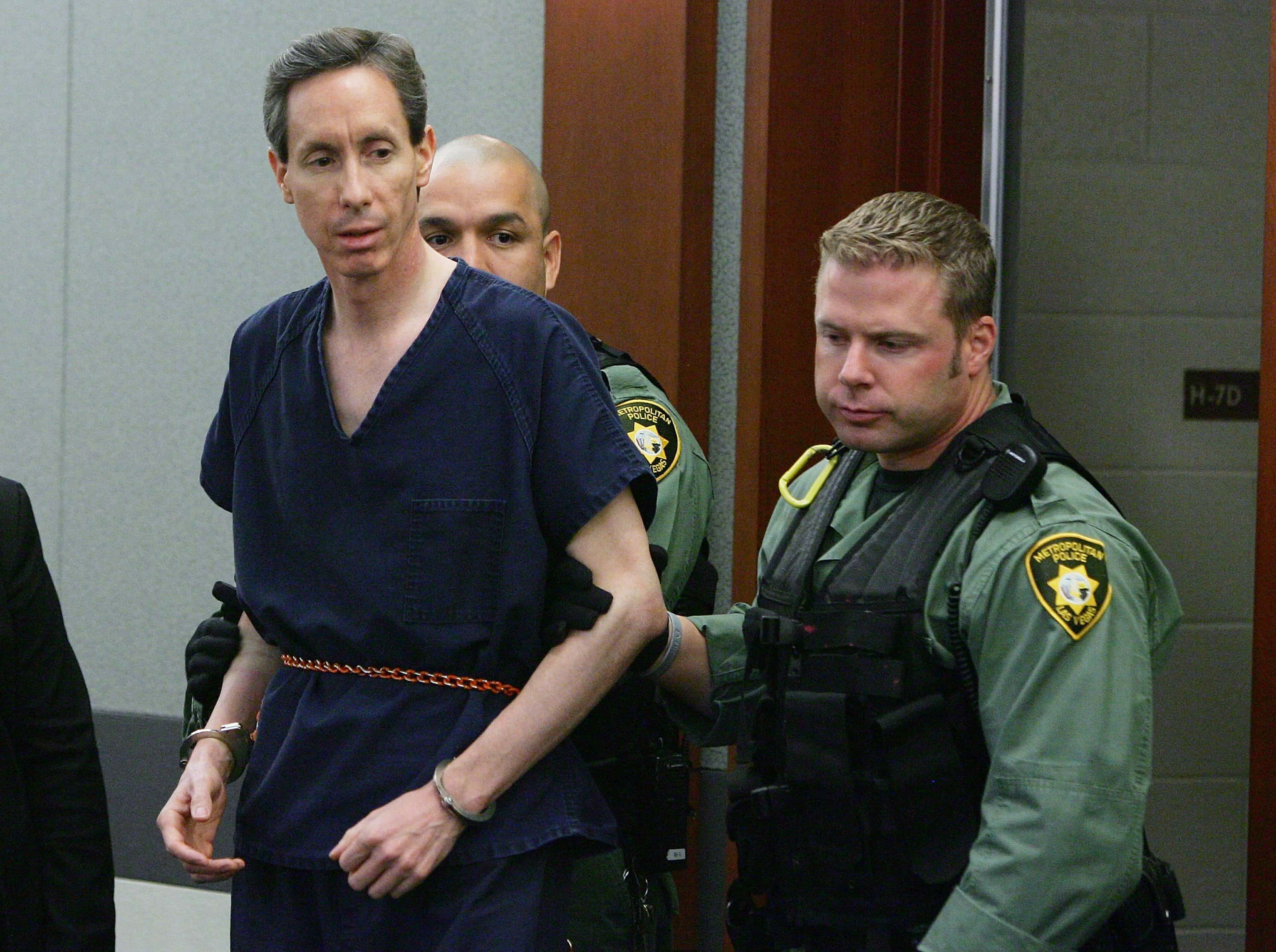 LAS VEGAS - AUGUST 31: Warren Jeffs (L) is led by Las Vegas Metropolitan Police Department SWAT officers into Las Vegas Justice Court for his extradition hearing at the Regional Justice Center August 31, 2006 in Las Vegas, Nevada. Jeffs, the fugitive leader of a polygamist Mormon sect who has been on the FBI's Ten Most Wanted List since May, will not fight extradition to Utah. He was arrested by a Nevada Highway Patrol trooper on August 28 during a traffic stop. Jeffs was wanted in Utah and Arizona on charges linked to allegations of arranging marriages between men and underage girls. (Photo by Ethan Miller/Getty Images)
