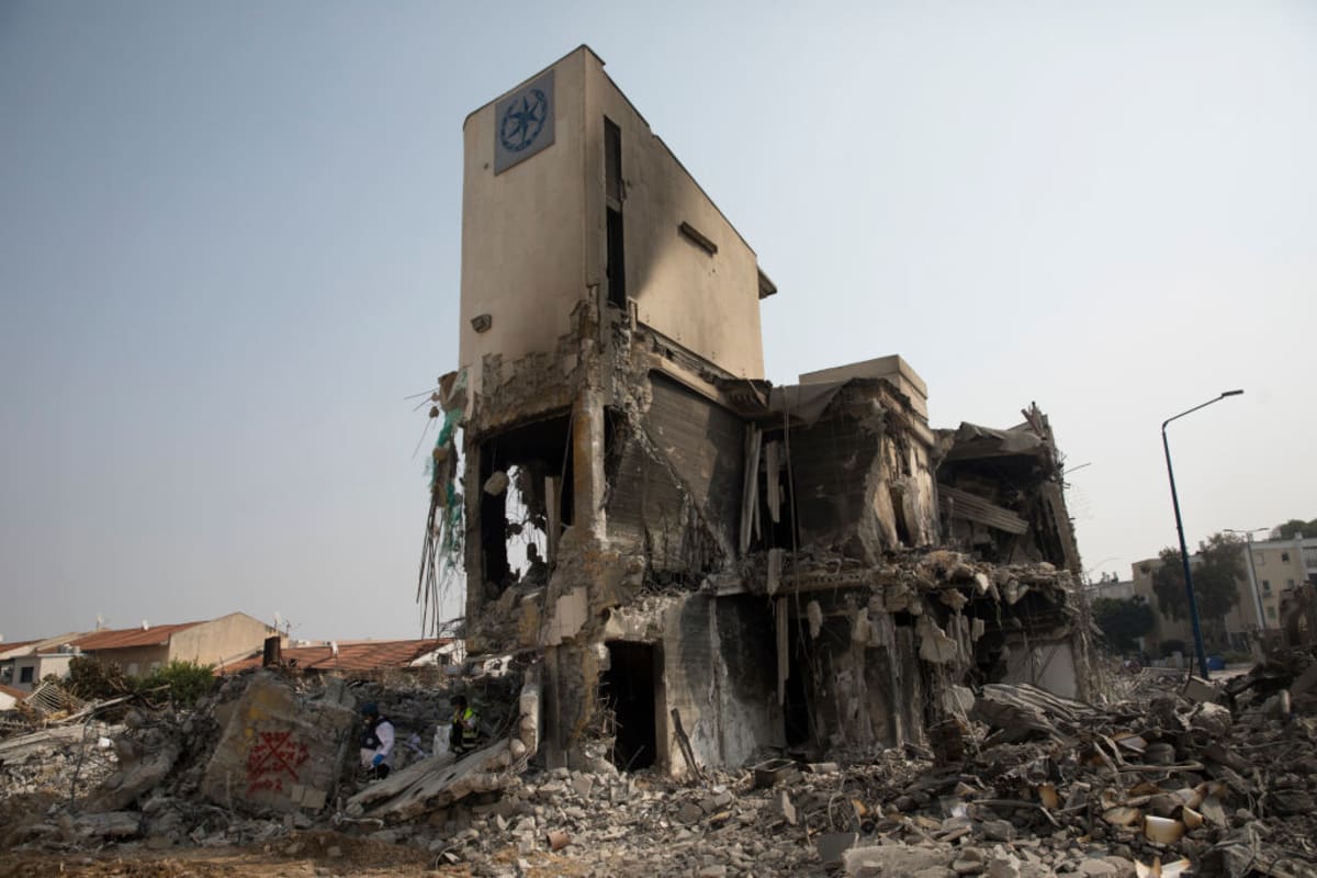 Israeli rescue members work at a police station that was destroyed after a battle between Israeli troops and Hamas militants on October 8, 2023 in Sderot, Israel.  (Photo by Amir Levy/Getty Images)
