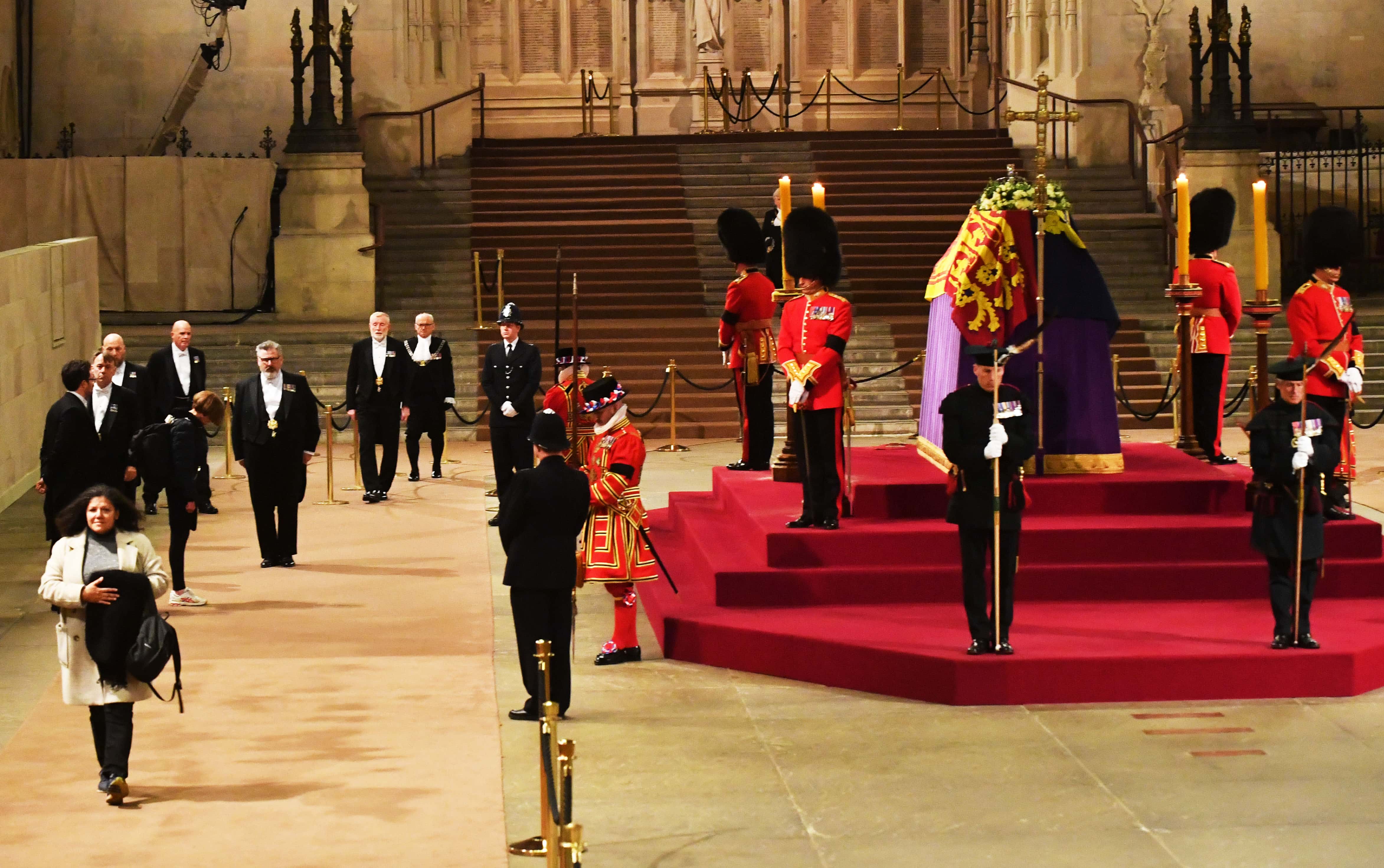 Christina Heerey (L), the last person to pay their respects, walks past the coffin of Queen Elizabeth II Lying-In-State in Westminster Hall on September 19, 2022 in London, England. Members of the public are able to pay respects to Her Majesty Queen Elizabeth II for 23 hours a day from 17:00 on September 18, 2022 until 06:30 on September 19, 2022. Queen Elizabeth II died at Balmoral Castle in Scotland on September 8, 2022, and is succeeded by her eldest son, King Charles III. (Photo by Mark Large - WPA Pool/Getty Images)