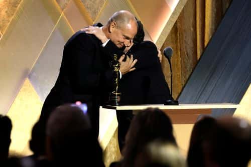 (L-R) Woody Harrelson presents Michael J. Fox with the Jean Hersholt Humanitarian Award onstage during the Academy of Motion Picture Arts and Sciences 13th Governors Awards at Fairmont Century Plaza on November 19, 2022 in Los Angeles, California. (Photo by Kevin Winter/Getty Images)