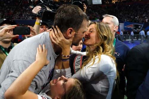 Tom Brady #12 of the New England Patriots kisses his wife Gisele Bündchen after the Super Bowl LIII against the Los Angeles Rams at Mercedes-Benz Stadium on February 3, 2019 in Atlanta, Georgia. The New England Patriots defeat the Los Angeles Rams 13-3.
