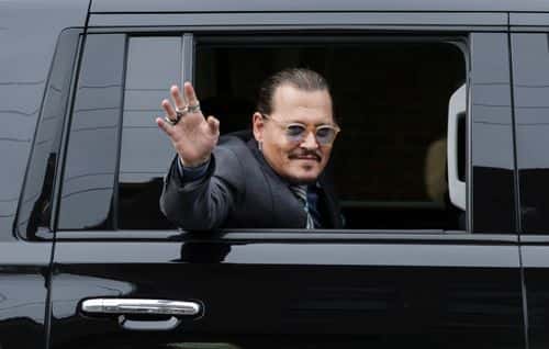 Actor Johnny Depp waves to supporters as he leaves the Fairfax County Courthouse on May 25, 2022 in Fairfax, Virginia. The Depp v. Heard, a defamation trial brought by Johnny Depp against his ex-wife Amber Heard is in its last week of trial with closing argument scheduled on this Friday.