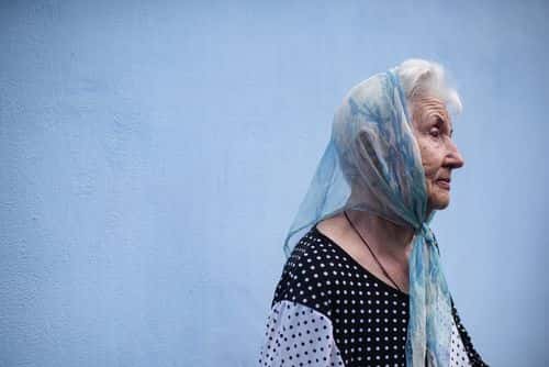 An elderly woman prays during the memorial service for Roman Ratushny in St. Michaels Cathedral on June 18, 2022 in Kyiv, Ukraine. Mr Ratushny was killed in battle on June 9 near Izium, southeast of Kharkiv. Roman Ratushny was a well-known Ukrainian civic activist. When he was 16, he participated in the Euromaidan revolution in Kyiv. Later he started campaigning against the illegal construction in a green zone in Kyiv.