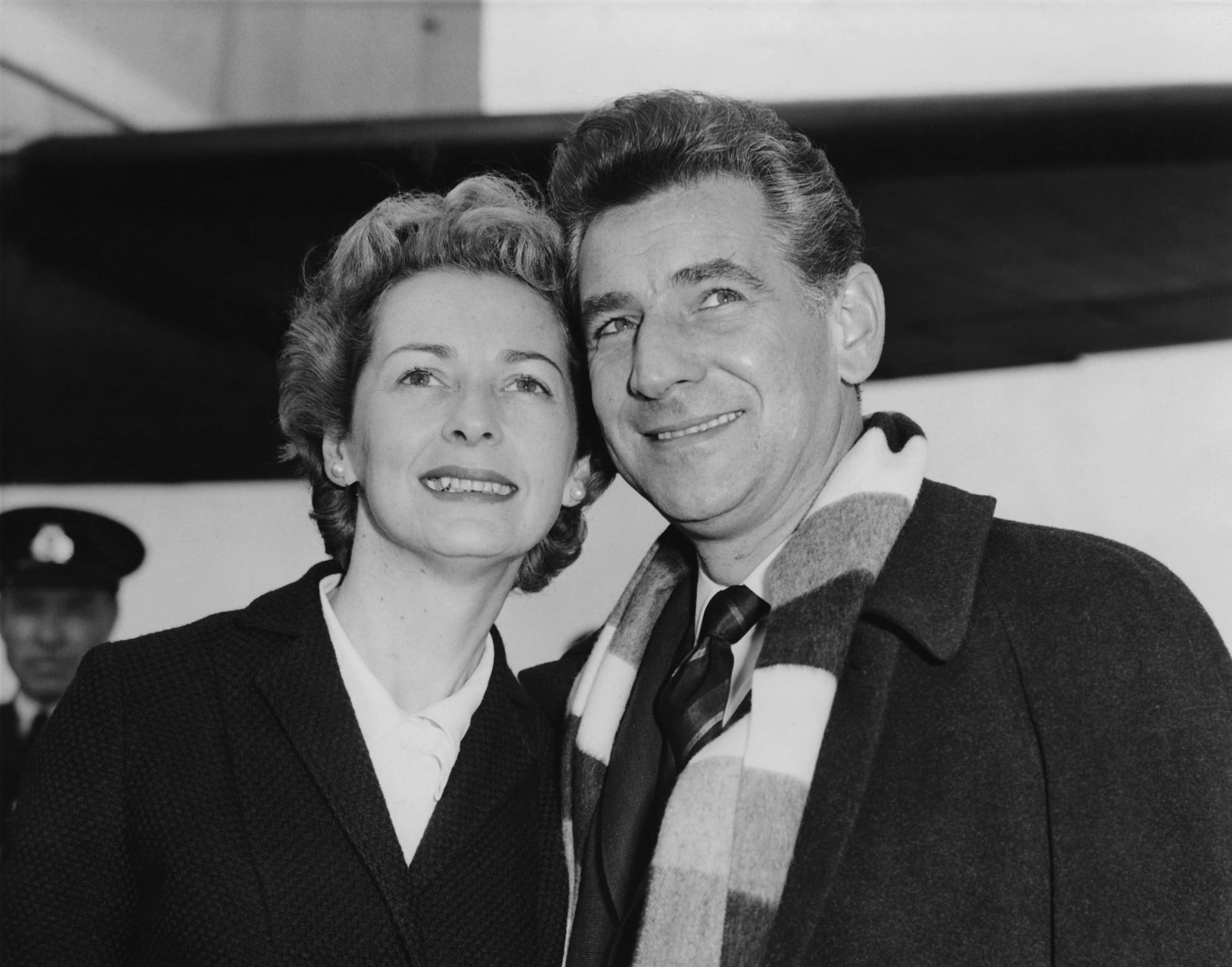 American composer Leonard Bernstein (1918 - 1990) arrives at London Airport with his wife, actress Felicia Montealegre (1922 - 1978), having flown in from Gothenburg in Sweden, 9th October 1959. (Photo by Lee/Central Press/Hulton Archive/Getty Images)