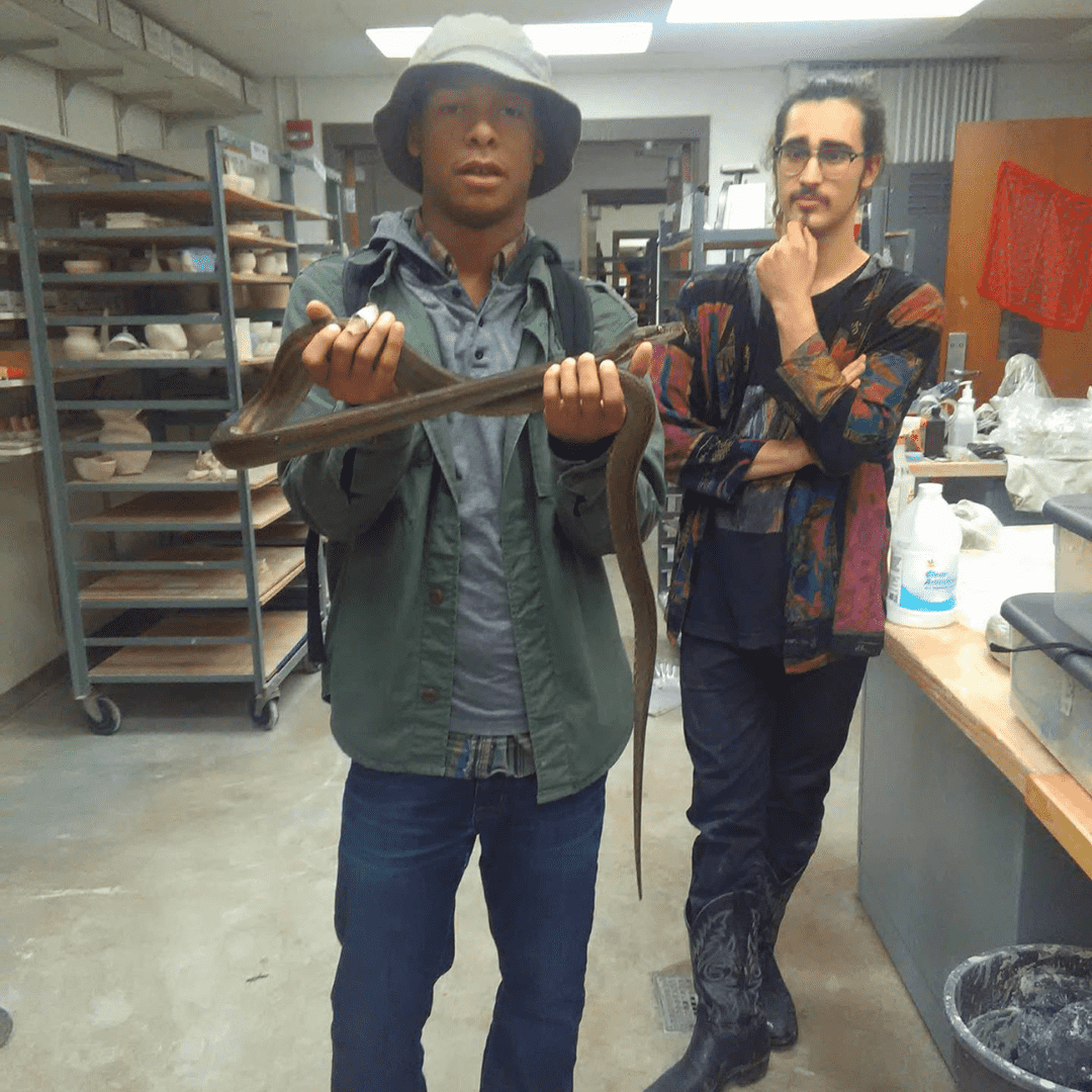 Jeremy Rios Griffin, left, and Elliot Senseman at Kutztown University in 2017. Griffin is holding one of Senseman's snakes, a reticulated python named Rolex. (Courtesy: Jeremy Rios Griffin via The Morning Call)