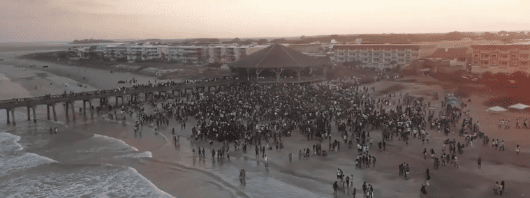 Chaos descended on Georgia's Tybee Island as more than 50,000 loud and boozy party goers danced and went wild at the Orange Crush party (WJCL News/Screengrab)