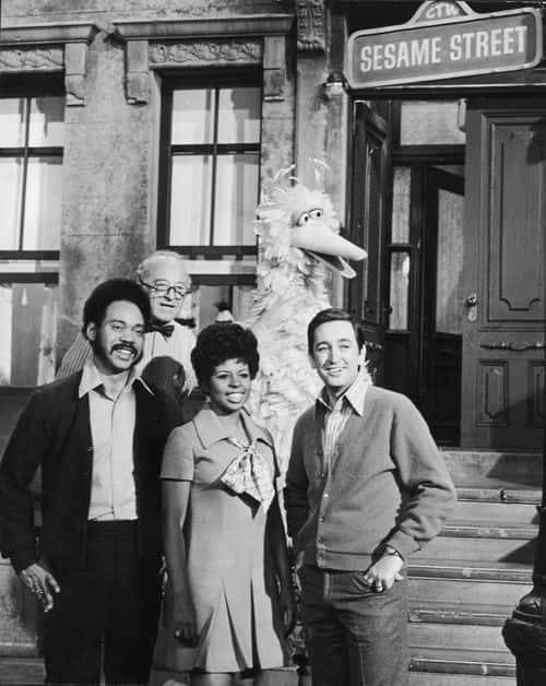 'Sesame Street' hosts Matt Robinson (Gordon), Will Lee (Mr. Hooper) Loretta Long (Susan) and Bob McGrath (Bob) stand with Big Bird in a promotional still on the set of the educational public television series, circa 1969.