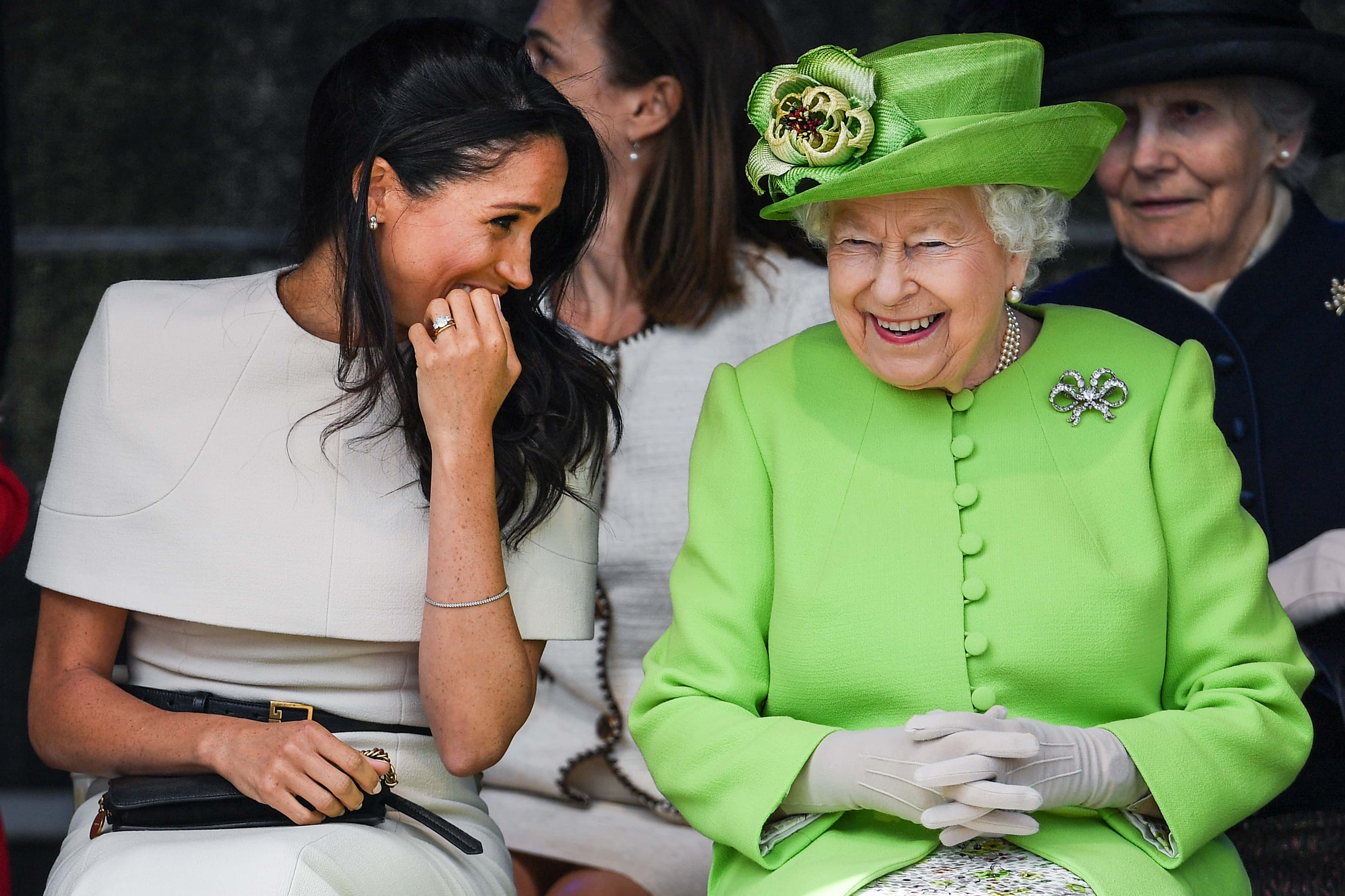 Queen Elizabeth II sitts and laughs with Meghan, Duchess of Sussex during a ceremony to open the new Mersey Gateway Bridge on June 14, 2018 in the town of Widnes in Halton, Cheshire, England. Meghan Markle married Prince Harry last month to become The Duchess of Sussex and this is her first engagement with the Queen. During the visit the pair will open a road bridge in Widnes and visit The Storyhouse and Town Hall in Chester.