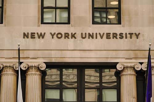 A view of New York University sign on the campus building. (Photo by John Nacion/SOPA Images/LightRocket via Getty Images)