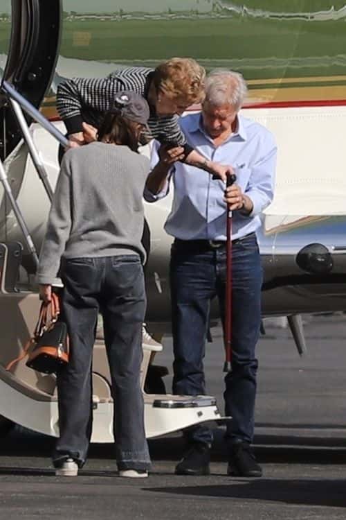 Ford helps mother-in-law out of the jet. (Backgrid)