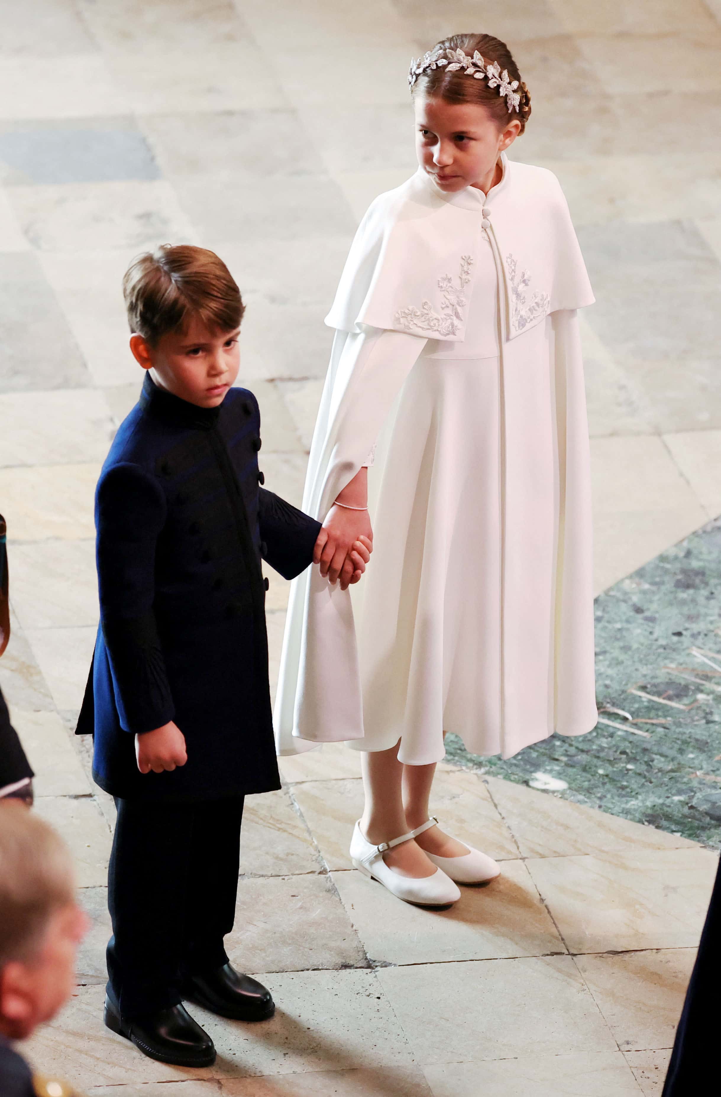 Princess Charlotte sweetly holds her Brother Prince Louis's hand at the coronation (Getty Images)
