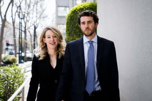 Former Theranos CEO Elizabeth Holmes alongside her boyfriend Billy Evans, leaves a hearing at the Robert E. Peckham U.S. Courthouse on March 17, 2023 in San Jose, California. Holmes appeared in court for a restitution hearing.