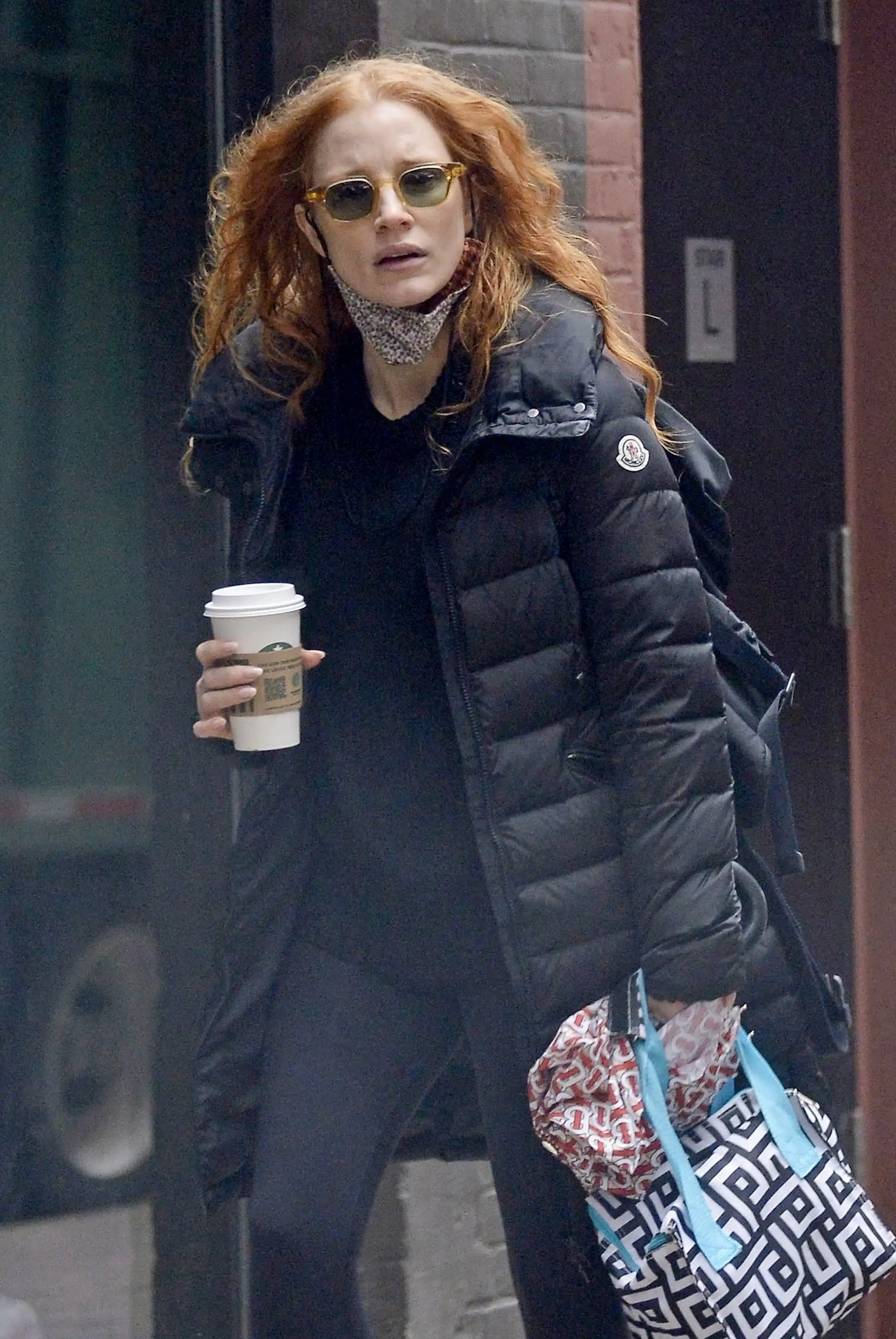 Jessica's look: Chastain stepped out with a black shirt under a black puffer coat, with a face mask dangling under her chin (backgrid)