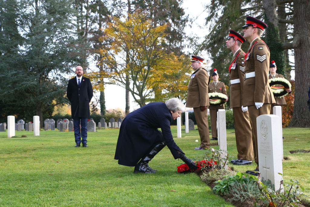 Prime Minister Theresa May (R) as Belgian Prime Minister Charles Michel looks on lays a wreath at the graves of John Parr, the first British soldier to be killed in 1914, and George Ellison, the last to be killed before Armistice at the St Symphorien Military Cemetery on November 9, 2018 in Mons, Belgium (Source: Gareth Fuller - WPA Pool/Getty Images)