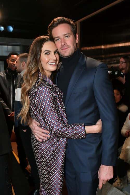 Actors Elizabeth Chambers (L) and husband  Armie Hammer pose for a photo at BOSS Menswear - Front Row at New York Fashion Week Mens' on February 7, 2018 in New York City.