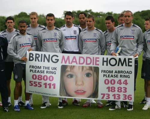 The England players hold a banner for the safe return of missing child Maddie McCann, before England B team training at the Carrington training ground on May 24, 2007 in Manchester, England. (Photo by Gary M. Prior/Getty Images).