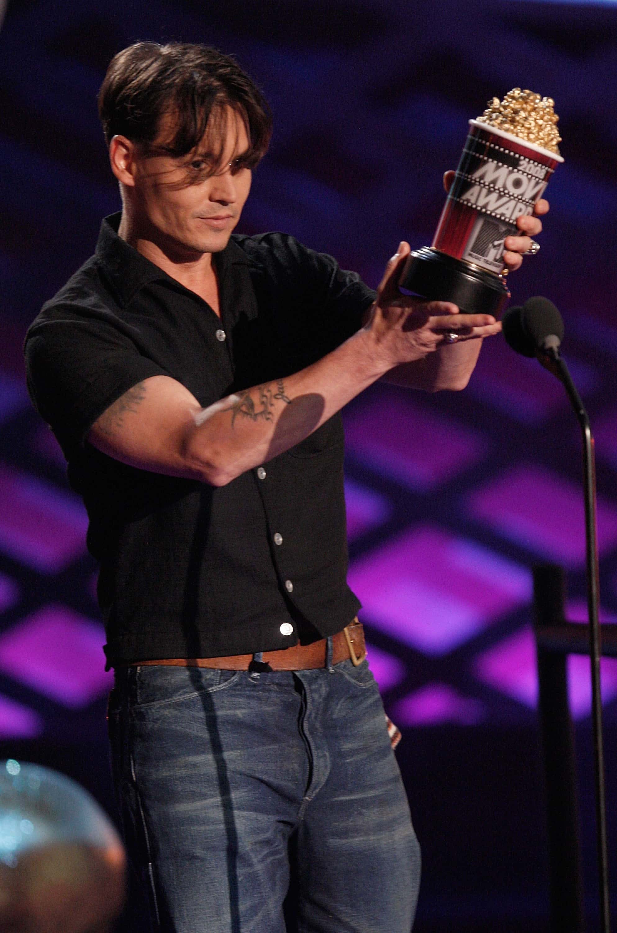 Actor Johnny Depp accepts the award for Best Villain for