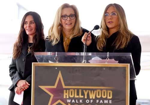 (L-R) Courteney Cox, Lisa Kudrow and Jennifer Aniston speak onstage during the Hollywood Walk of Fame Star Ceremony for Courteney Cox on February 27, 2023 in Hollywood, California.