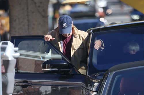 While walking back to his car, the 'Die Hard' star rocked a beige coat, maroon long sleeve shirt and dark-wash jeans. (Backgrid)