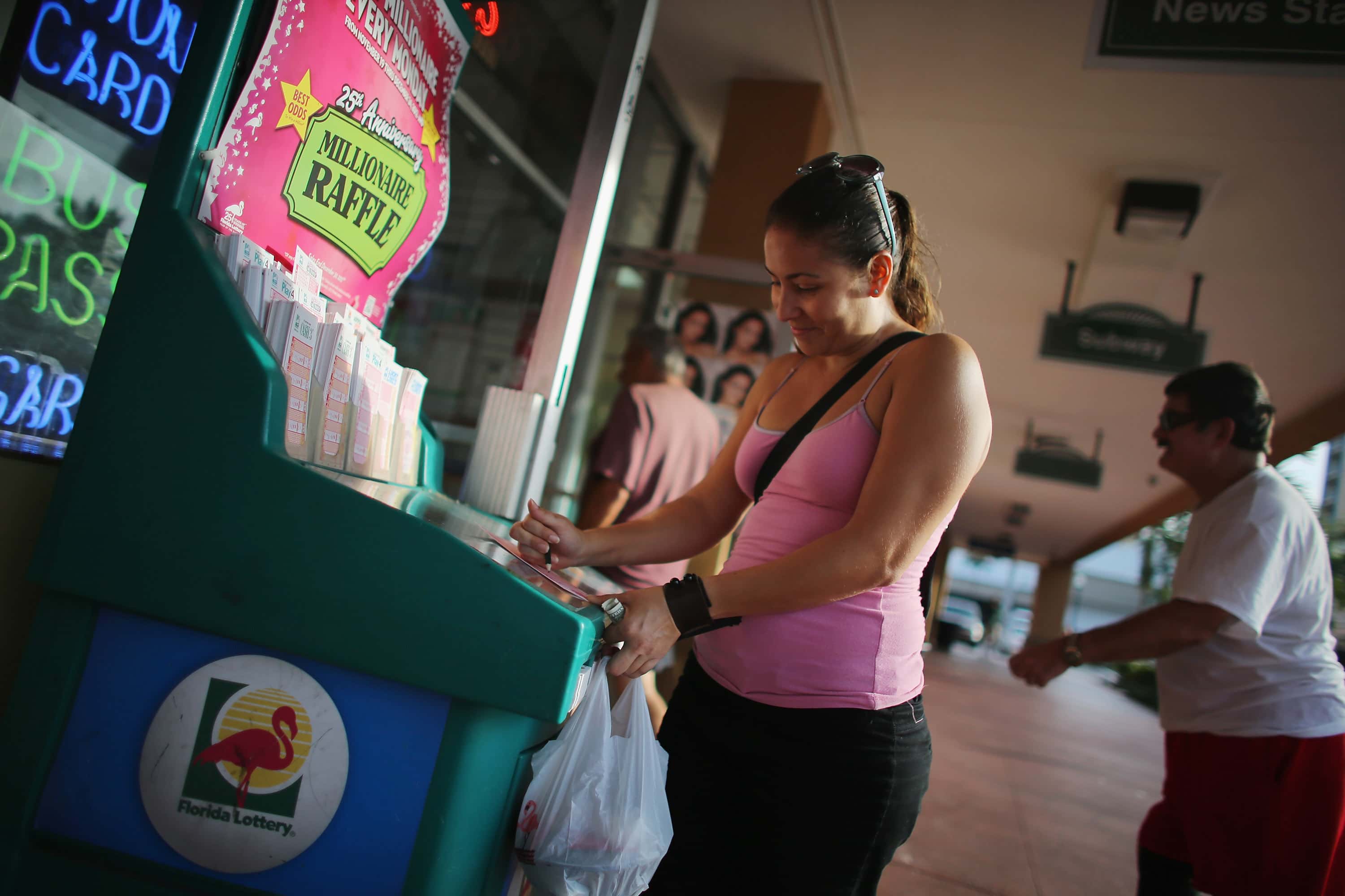 HOLLYWOOD, FL - NOVEMBER 27: Vanessa Lopez fills out her Powerball numbers as she buys tickets at Circle News Stand on November 27, 2012 in Hollywood, Florida. The jackpot for Wednesday's Powerball drawing is currently at $500 million which is the richest Powerball pot ever. It is likely to rise even more as people continue to buy. (Photo by Joe Raedle/Getty Images)