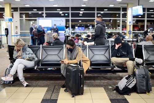 Passengers wait to board an American Airlines flight to Dallas at the Ronald Reagan Washington National Airport on November 24, 2021 in Arlington, Virginia. FAA expects the number of travelers for Thanksgiving to reach pre-pandemic levels, with more than 53 million people traveling in total in the days leading up to the holiday.
