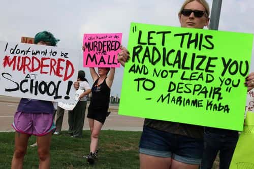 People protest against gun violence outside of the Cotton wood Creek Baptist Church on May 7, 2023 in Allen, Texas. A vigil is being held at the church for victims of the mass shooting in the Allen Premium Outlets mall on May 6th. According to reports, a shooter opened fire at the outlet mall, killing eight people. The gunman was then killed by an Allen Police officer that was responding to an unrelated call.