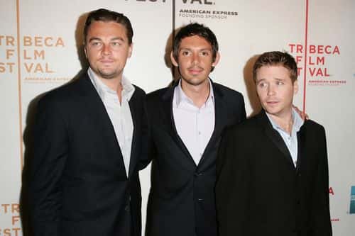 Actors Leonardo DiCaprio and Lukas Haas pose with director Kevin Connolly at the premiere of 